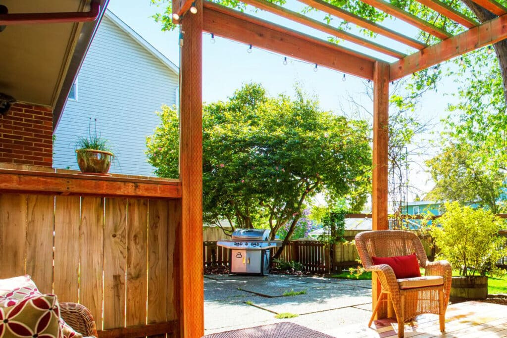 Garden Pergola Intalled By Landscaper With Garden Barbeque And Outdoor Furniture